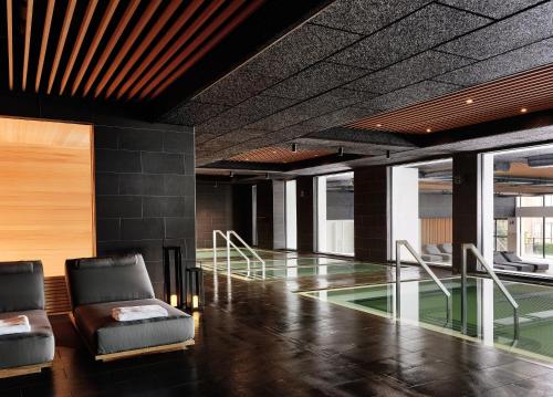 a lobby with two chairs and a glass floor at Gurney's Montauk Resort & Seawater Spa in Montauk