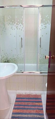 a bathroom with a tub and a sink and a shower at Baleal Sol Alojamentos in Baleal