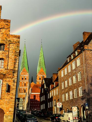 a group of tall buildings with green towers at The Layhead B&B in Lübeck