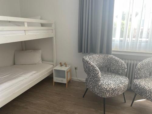 a bedroom with a bunk bed and a chair and a bed and a bed at Hotel Lammerts in Horn-Bad Meinberg