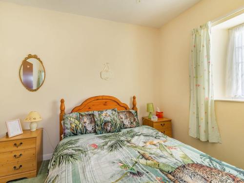 a bedroom with a bed and a window at Feather Holme Farm Cottage in Hawnby