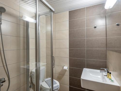 a bathroom with a shower and a sink and a toilet at Nontas suites in Kato Daratso