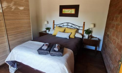 a bedroom with a bed with two towels on it at Lina House Garden, BBQ & Outdoor Dining in Puntagorda