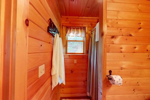 a hallway in a log cabin with a window at Lenas' Lakeside Cabin in Waterville