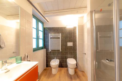 a bathroom with a toilet and a sink and a shower at Mura 5&7 in Trieste
