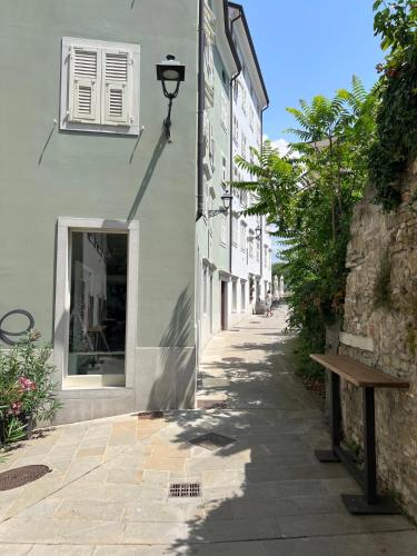 a street with a bench next to a building at Mura 5&7 in Trieste