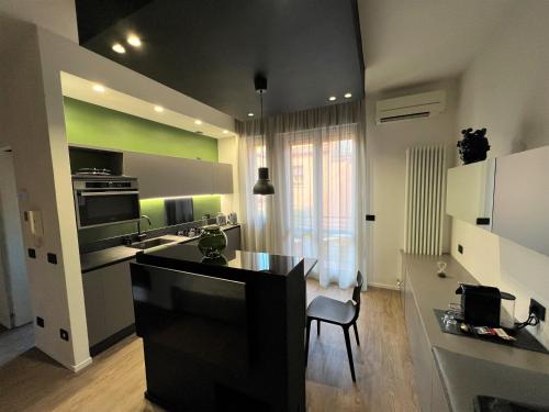 a kitchen with a black island in a room at Alfea Suite in Bologna