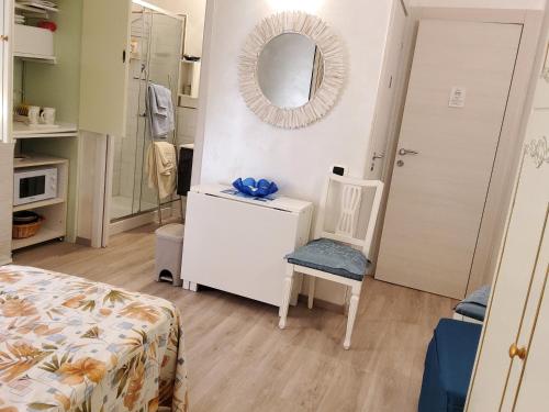 a small room with a mirror and a chair at Annadia Sweet Home B&B in Lido di Ostia