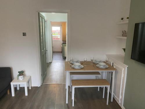 a dining room with a table and chairs and a hallway at Montrose - Perfect Contractor Stay Own Driveway 3 bedrooms in Gateshead