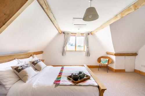 a bedroom with a large bed in a attic at Self-Catering at Craft Renaissance in Usk