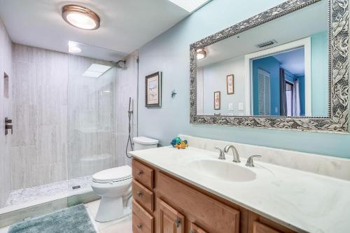 a bathroom with a sink and a toilet and a mirror at Arie Dam 304 in St Pete Beach