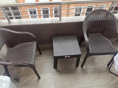 two chairs and a table on a balcony at Jana apartment 2 in Ohrid