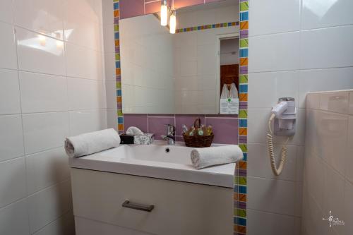 a bathroom with a sink and a mirror at Chalet Hôtel Les Blancs in Pra-Loup