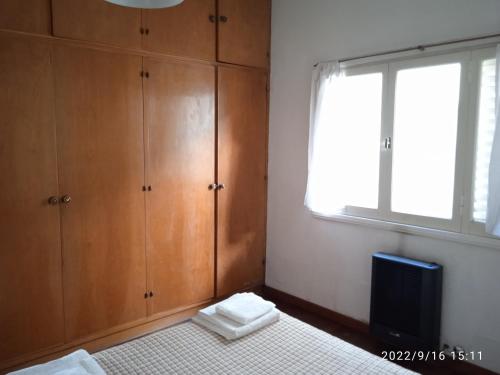 a bedroom with a bed and a television and a window at Villa Lidia in Mar del Plata