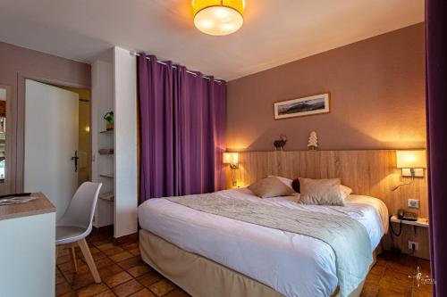 a bedroom with a large bed with purple curtains at Chalet Hôtel Les Blancs in Pra-Loup