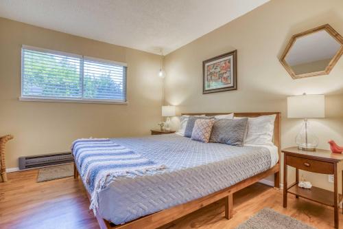 a bedroom with a large bed and a window at Creekside Condo 136 - Meredith Lodging in Neskowin