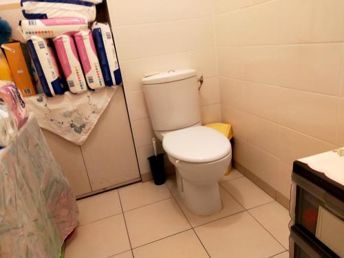 a bathroom with a white toilet in a room at a nice room in Annemasse