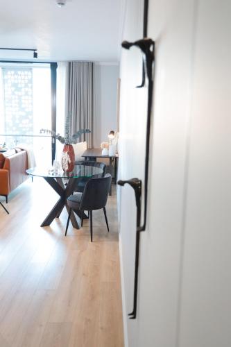 a living room with a table and a dining room at Luxury Apartment at Ellipse Waterfall, Midrand Near Mall of Africa in Midrand