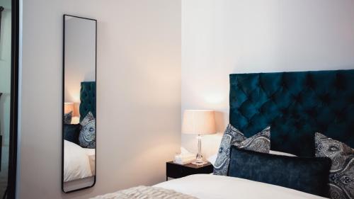 a bedroom with a large mirror and a bed at Luxury Apartment at Ellipse Waterfall, Midrand Near Mall of Africa in Midrand