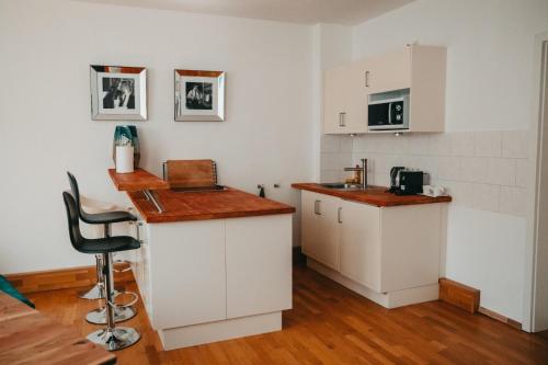 a kitchen with white cabinets and a counter top at Jalda Apartments in Düsseldorf