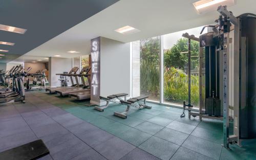a gym with tread machines and a large window at Holiday Inn Bogota Airport by IHG in Bogotá