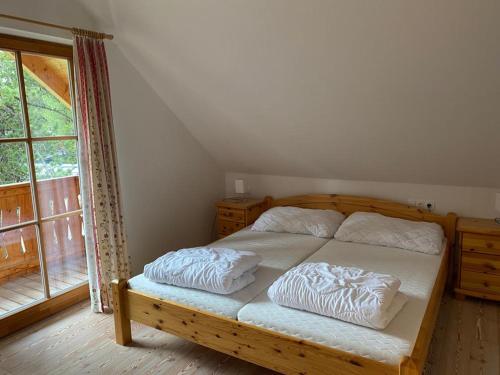 a bedroom with a bed with two pillows on it at Turrach Chalet Haus Dachs in Ebene Reichenau