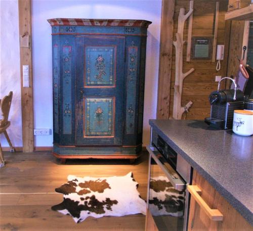a large blue cabinet in a room with a cow on the floor at Superior Suite Bergparadies Sauna - barrierfree in Inzell