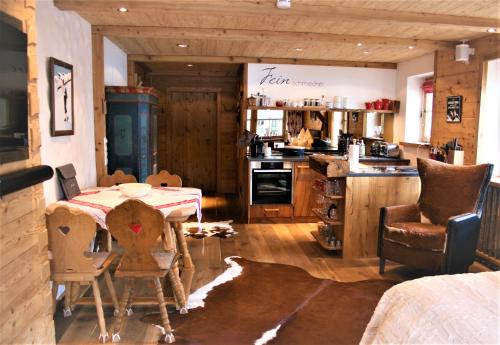 a kitchen with a table and chairs in a room at Superior Suite Bergparadies Sauna - barrierfree in Inzell