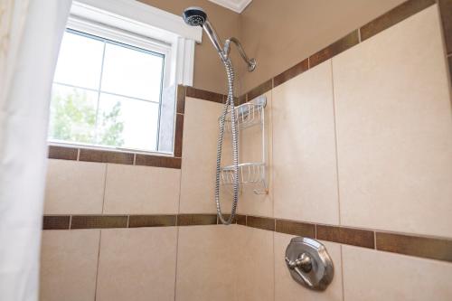 a shower in a bathroom with a window at Downtown Whitehorse Apartment in Old Town in Whitehorse