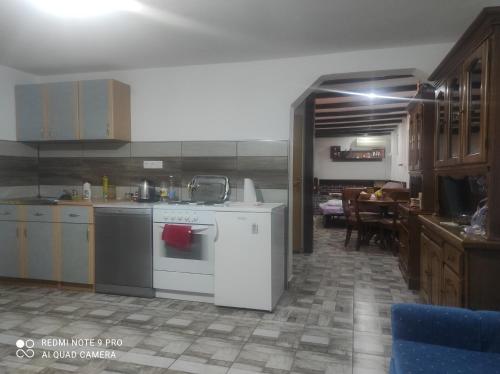 a kitchen with a white stove and a table at Home of nature - kuća prirode in Odžak