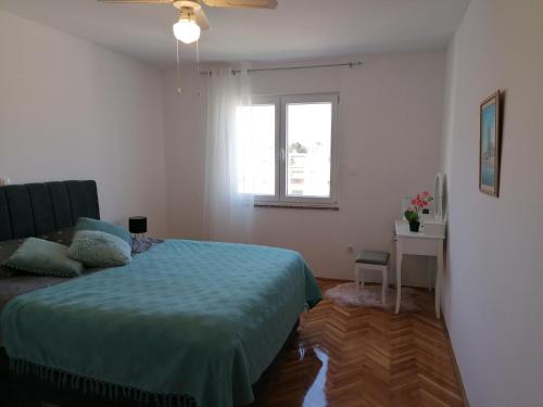 a bedroom with a bed and a window at Sunny spot in Pula