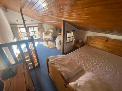 a bedroom with a bed and a wooden ceiling at Appartement face Mont Blanc in Demi-Quartier