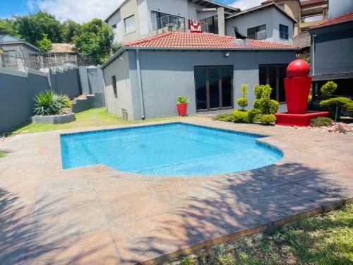 a swimming pool in the backyard of a house at Toriso Hotels Group in Nelspruit