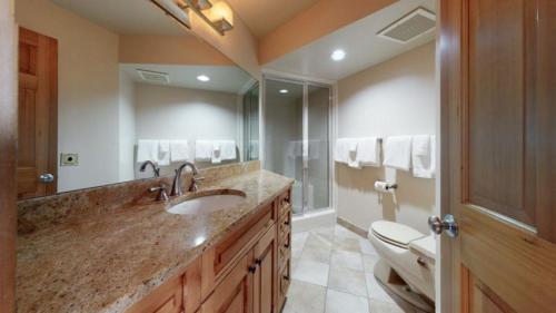 a bathroom with a sink and a toilet and a mirror at Ski In, Ski Out, 2 Bedroom Luxury Residence In Snowmass Village in Snowmass Village