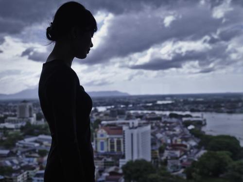a woman standing on top of a city at Pullman Kuching in Kuching