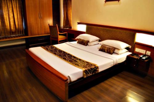 a bedroom with a large bed in a room at Malligi,Hampi in Hospet