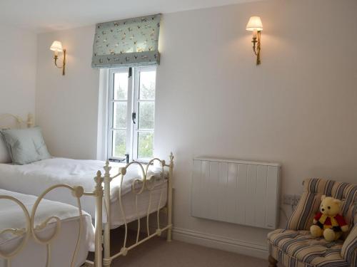 Ένα ή περισσότερα κρεβάτια σε δωμάτιο στο Grattan Cottage