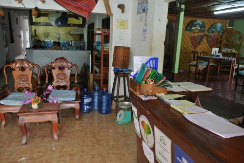 a room with chairs and a counter in a store at Pan's Place in Vang Vieng