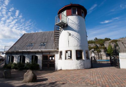 a lighthouse with a balcony on top of it at Skottevik Feriesenter in Skottevik