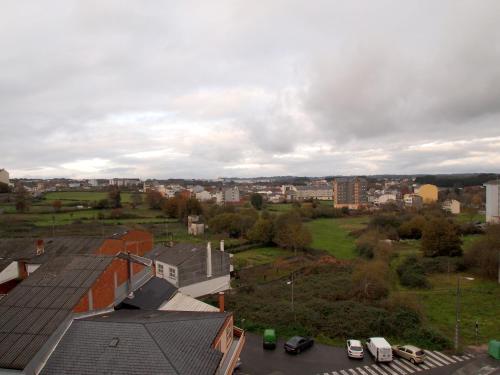 a view of a city with cars and buildings at U-Hotel Darío Lugo in Lugo