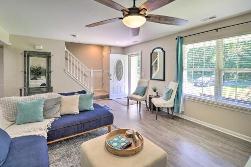 a living room with a blue couch and a ceiling fan at Walk to the Beach with Deck, Fireplace, BBQ Grill, Boat Ramp & Office in Chestertown