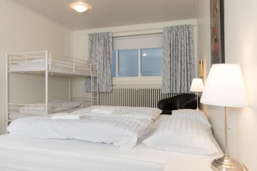 a bedroom with two beds and a bunk bed at Ljosafoss Guest House in Selfoss