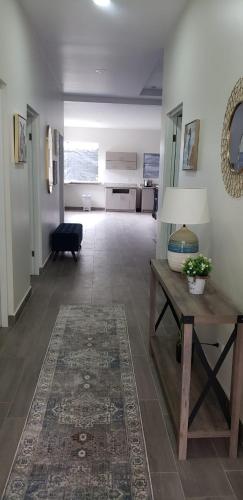 a living room with a table and a rug at Casa en puntaleona Condomio Bambu in Quebrada Ganado