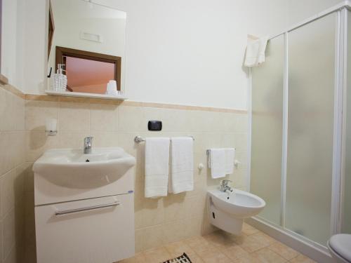 a bathroom with a sink and a toilet and a shower at B&B Rosa podere 28 in Palagianello