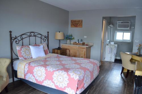 a bedroom with a bed and a desk and a table at Gateway Inn in Chicago