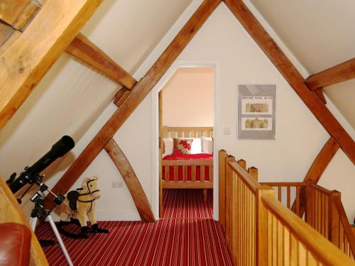 a attic room with a camera and a bedroom at The Hayloft in Chislet