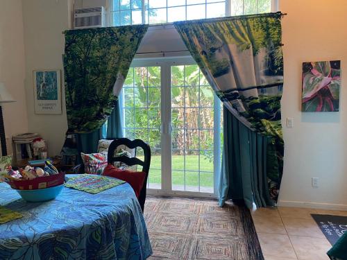 a bedroom with a bed and a large window at Heavenly Hana Paradise in Hana