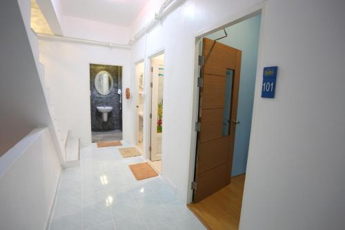 a hallway with a bathroom with a toilet and a door at iDeal Beds Hostel Ao Nang Beach in Ao Nang Beach