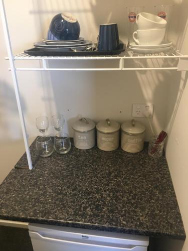 a refrigerator with some dishes and glasses in it at Lakeview Terrace Accommodation in Cromwell