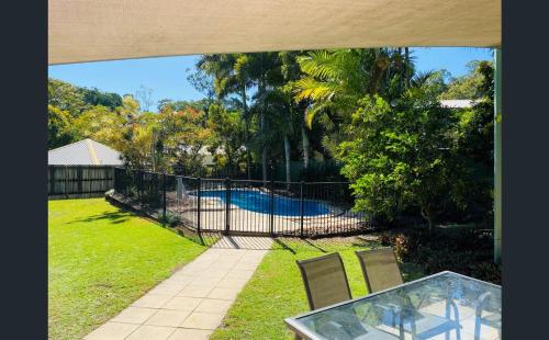 a view of a yard with a fence and a pool at Rainbow Beach House in Rainbow Beach